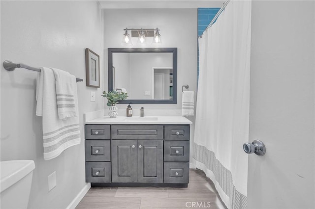 6721 E Coralite St, Long Beach, CA 90808 - full bathroom with vanity, wood finished floors, and a shower with curtain