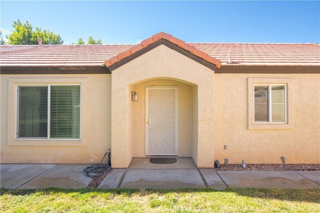 19078 Stoddard Way, Apple Valley, CA 92308 - view of exterior entry with stucco siding and a patio