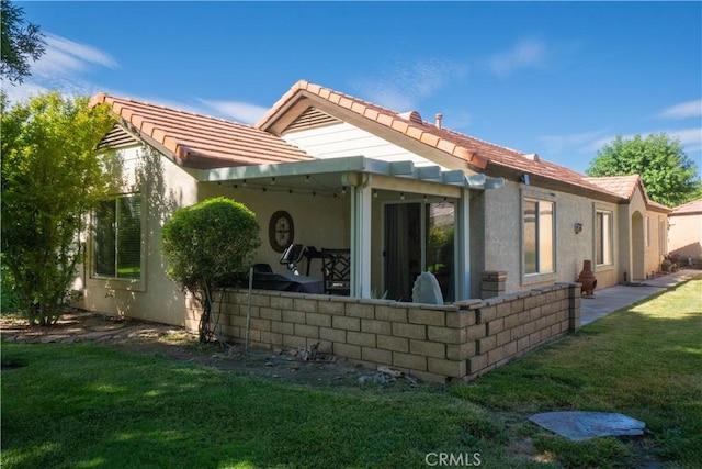 19078 Stoddard Way, Apple Valley, CA 92308 - rear view of house featuring a lawn, a tile roof, and stucco siding