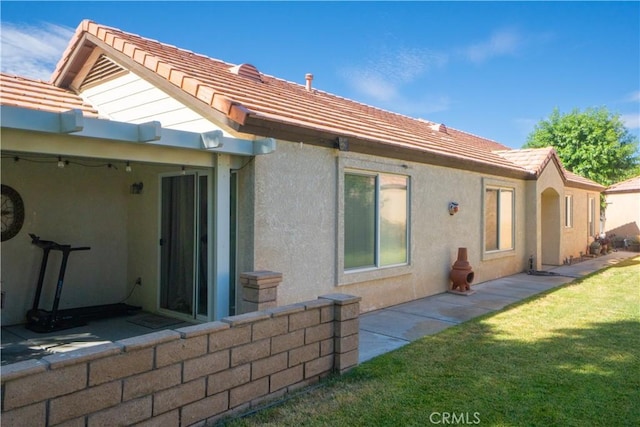 19078 Stoddard Way, Apple Valley, CA 92308 - back of house featuring stucco siding, a lawn, a tiled roof, and a patio area