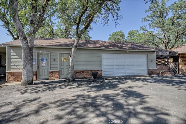 790 Manzanita St, Lakeport, CA 95453 - view of front of home with driveway, a garage, and brick siding