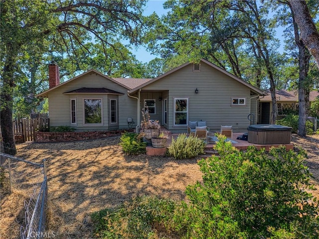 790 Manzanita St, Lakeport, CA 95453 - rear view of property with a hot tub, a fenced backyard, a chimney, and a deck