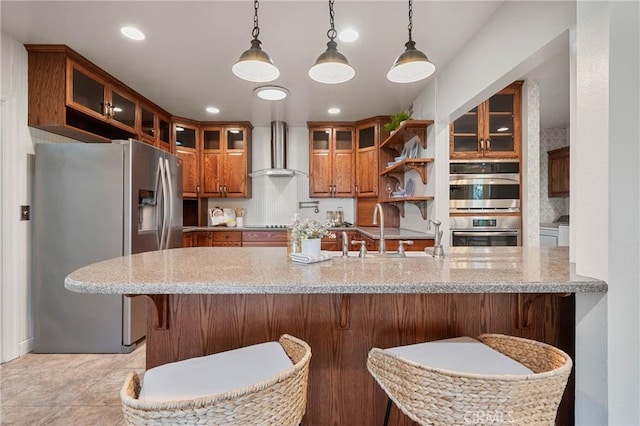 790 Manzanita St, Lakeport, CA 95453 - kitchen featuring appliances with stainless steel finishes, wall chimney range hood, brown cabinetry, light stone counters, and pendant lighting