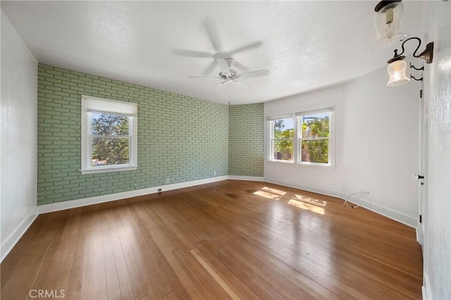 790 Manzanita St, Lakeport, CA 95453 - unfurnished room featuring ceiling fan, hardwood / wood-style flooring, and brick wall