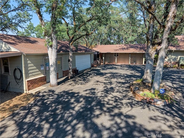 790 Manzanita St, Lakeport, CA 95453 - view of front of home with asphalt driveway, brick siding, and an attached garage