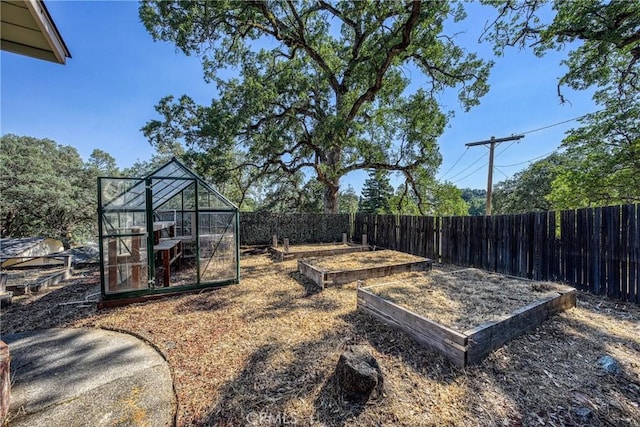790 Manzanita St, Lakeport, CA 95453 - fenced backyard with a garden, a greenhouse, and an outbuilding