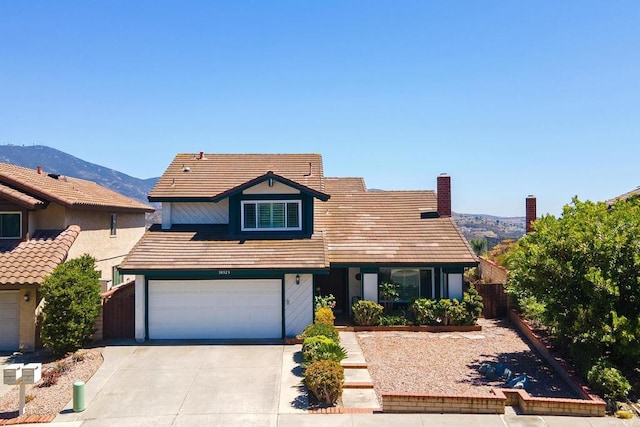 10323 Pine Grove St, Spring Valley, CA 91978 - traditional home featuring an attached garage, driveway, a mountain view, and a tile roof