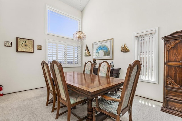 10323 Pine Grove St, Spring Valley, CA 91978 - dining area with carpet, a towering ceiling, and a chandelier