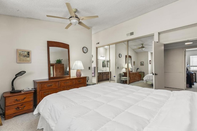 10323 Pine Grove St, Spring Valley, CA 91978 - bedroom with light carpet, a closet, a textured ceiling, ensuite bath, and ceiling fan