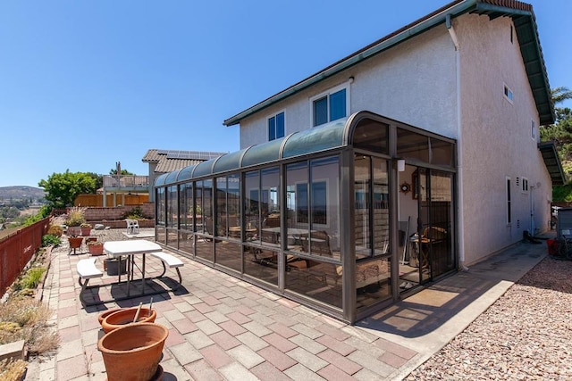 10323 Pine Grove St, Spring Valley, CA 91978 - back of property featuring a sunroom, a patio area, and stucco siding
