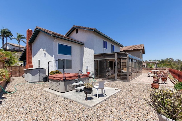 10323 Pine Grove St, Spring Valley, CA 91978 - back of house with a hot tub, a sunroom, a patio, a fenced backyard, and a chimney