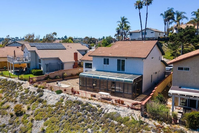 10323 Pine Grove St, Spring Valley, CA 91978 - back of property with a sunroom, a residential view, stucco siding, a tile roof, and a fenced backyard