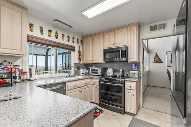 10323 Pine Grove St, Spring Valley, CA 91978 - kitchen featuring appliances with stainless steel finishes, light brown cabinets, tasteful backsplash, and light tile patterned flooring