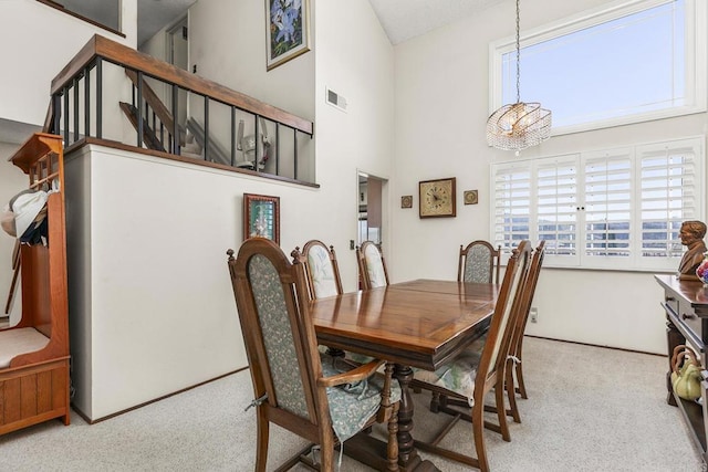 10323 Pine Grove St, Spring Valley, CA 91978 - dining room with carpet, a chandelier, a towering ceiling, and stairway