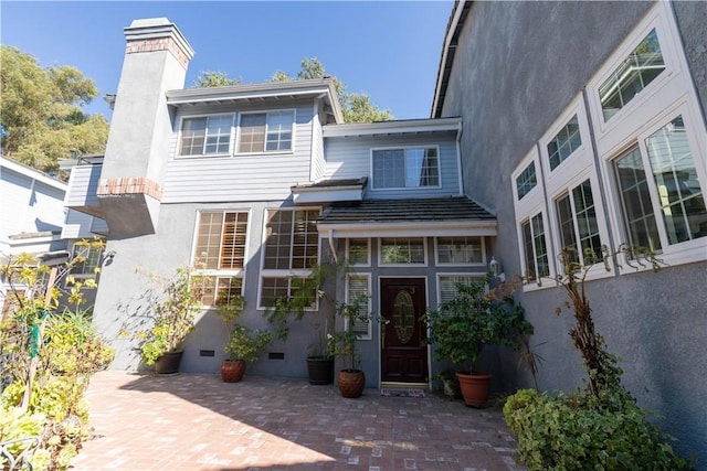23169 Mulholland Dr Unit 3, Woodland Hills, CA 91364 - back of property featuring a chimney, stucco siding, a patio, and crawl space