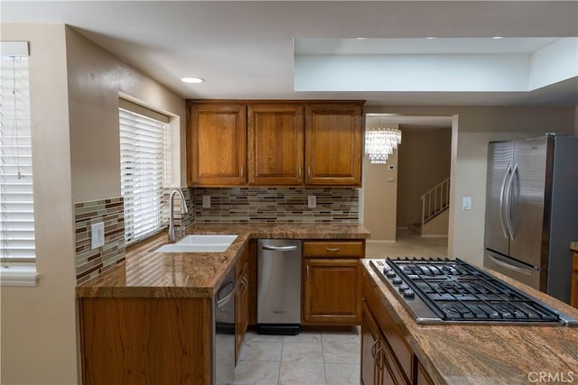 23169 Mulholland Dr Unit 3, Woodland Hills, CA 91364 - kitchen with stainless steel appliances, brown cabinetry, backsplash, light tile patterned floors, and recessed lighting