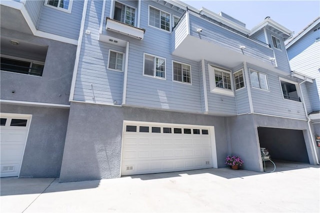 23169 Mulholland Dr Unit 3, Woodland Hills, CA 91364 - rear view of house with a garage and stucco siding