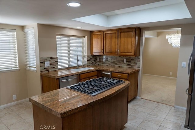 23169 Mulholland Dr Unit 3, Woodland Hills, CA 91364 - kitchen featuring appliances with stainless steel finishes, brown cabinetry, a chandelier, tasteful backsplash, and recessed lighting
