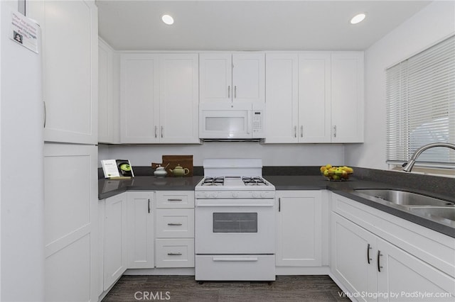 5473 Twin Lakes Dr, Cypress, CA 90630 - kitchen with white appliances, dark wood finished floors, white cabinetry, dark countertops, and recessed lighting