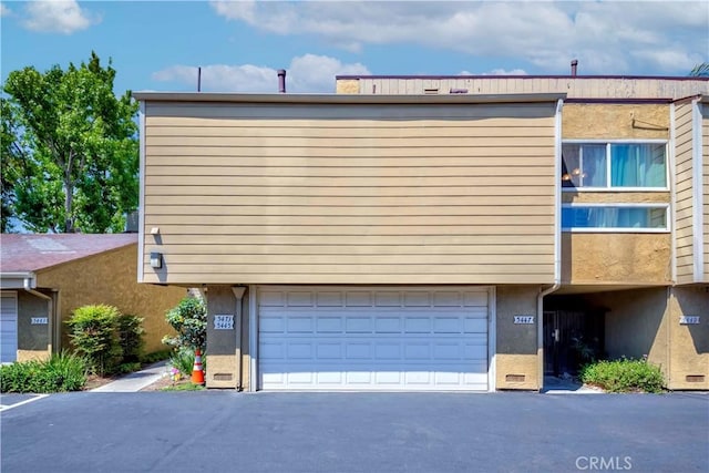 5473 Twin Lakes Dr, Cypress, CA 90630 - view of property exterior with stucco siding and an attached garage