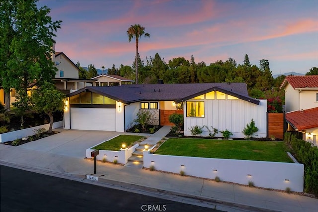 12350 Mclennan Ave, Granada Hills, CA 91344 - view of front facade featuring board and batten siding, driveway, and a garage