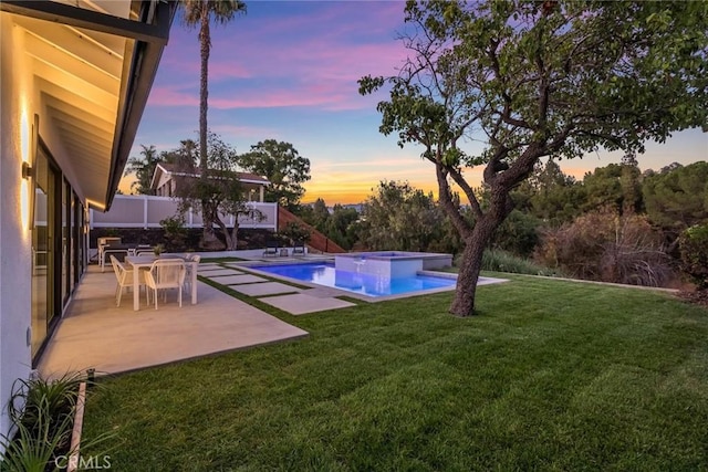 12350 Mclennan Ave, Granada Hills, CA 91344 - pool at dusk with a lawn, a patio area, and a pool with connected hot tub