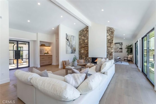 12350 Mclennan Ave, Granada Hills, CA 91344 - living room featuring light wood-style floors, french doors, recessed lighting, and a stone fireplace