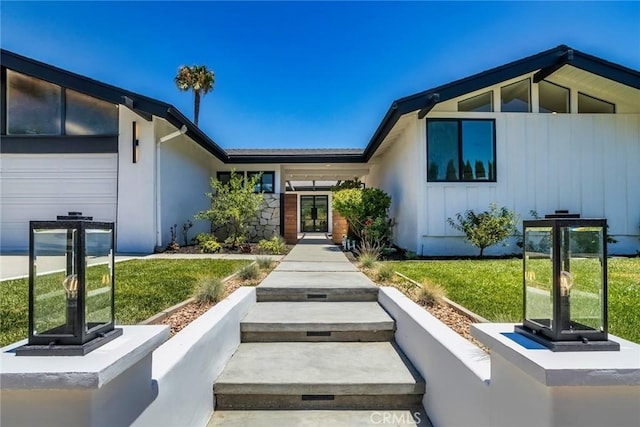 12350 Mclennan Ave, Granada Hills, CA 91344 - property entrance featuring board and batten siding, french doors, and a lawn