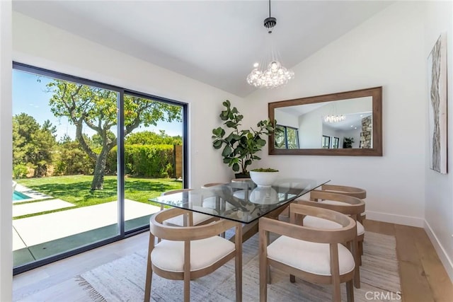 12350 Mclennan Ave, Granada Hills, CA 91344 - dining room featuring wood finished floors, a chandelier, and lofted ceiling