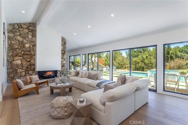 12350 Mclennan Ave, Granada Hills, CA 91344 - living area featuring wood finished floors and a stone fireplace