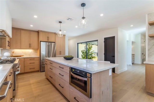 12350 Mclennan Ave, Granada Hills, CA 91344 - kitchen featuring light brown cabinetry, high end appliances, light wood-type flooring, recessed lighting, and decorative light fixtures
