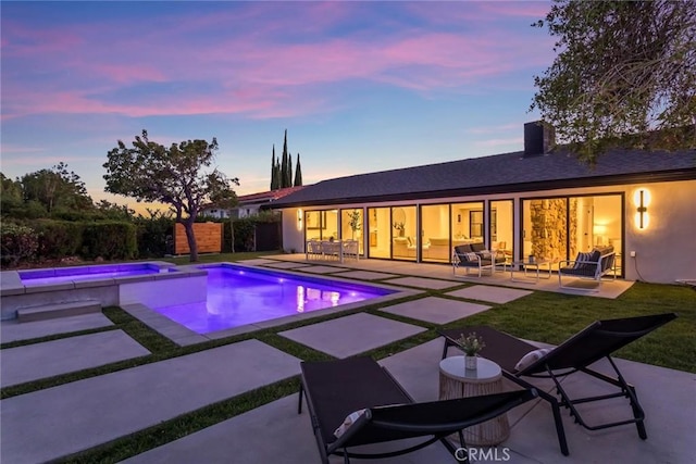 12350 Mclennan Ave, Granada Hills, CA 91344 - pool at dusk featuring a patio area, an outdoor living space, and a pool with connected hot tub