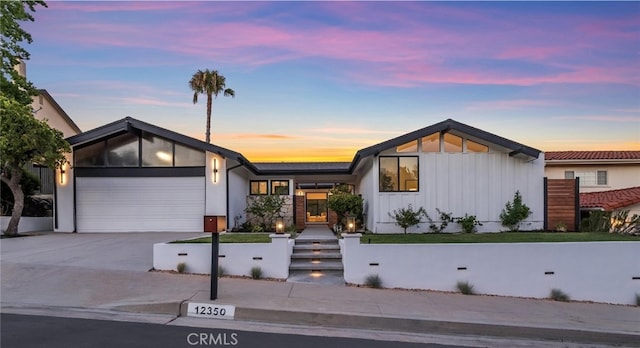 12350 Mclennan Ave, Granada Hills, CA 91344 - view of front of property featuring board and batten siding, a garage, and driveway