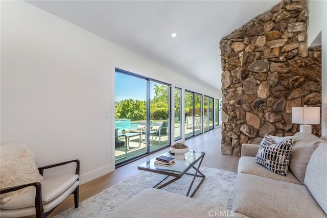 12350 Mclennan Ave, Granada Hills, CA 91344 - living area featuring wood finished floors, vaulted ceiling, and recessed lighting
