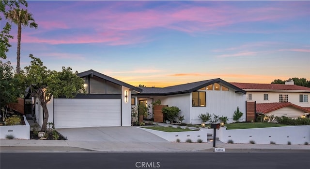 12350 Mclennan Ave, Granada Hills, CA 91344 - view of front of home featuring a garage, concrete driveway, and a chimney