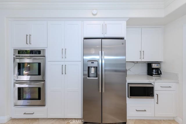 4330 E Cornwall Ave, Orange, CA 92867 - kitchen with appliances with stainless steel finishes, light stone counters, white cabinets, and decorative backsplash