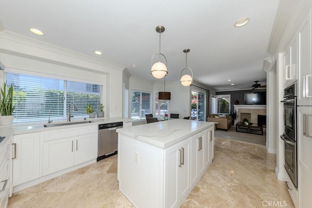 4330 E Cornwall Ave, Orange, CA 92867 - kitchen featuring appliances with stainless steel finishes, ceiling fan, a center island, light stone counters, and white cabinetry