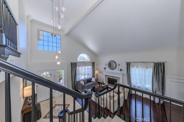 4330 E Cornwall Ave, Orange, CA 92867 - staircase with ornamental molding, high vaulted ceiling, a fireplace, and beamed ceiling