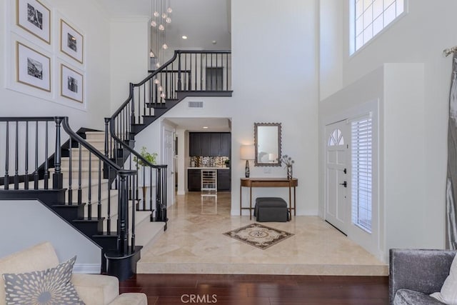 4330 E Cornwall Ave, Orange, CA 92867 - entryway featuring wine cooler, healthy amount of natural light, a high ceiling, and stairs