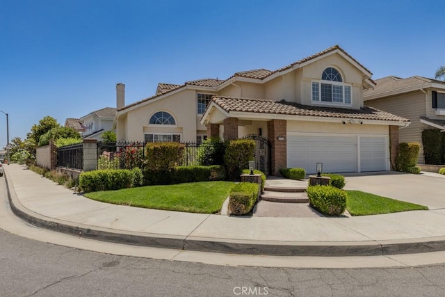 4330 E Cornwall Ave, Orange, CA 92867 - view of front of home featuring concrete driveway, an attached garage, stucco siding, a tiled roof, and brick siding