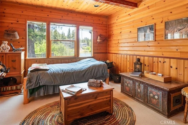 115 Lagunita Ln, Big Bear Lake, CA 92315 - bedroom featuring light colored carpet, wood walls, and a wooden ceiling with exposed beams