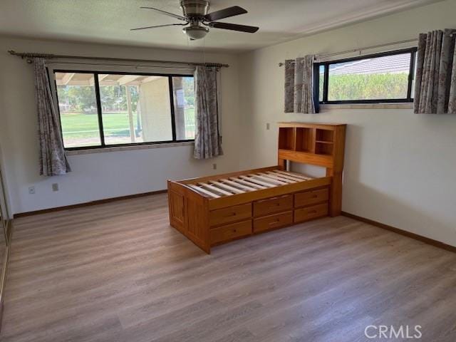 15163 Tournament Dr, Helendale, CA 92342 - bedroom featuring light wood finished floors, multiple windows, and a ceiling fan