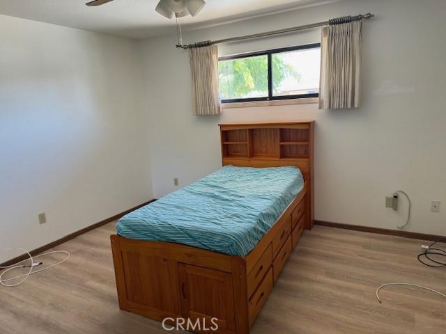 15163 Tournament Dr, Helendale, CA 92342 - bedroom with light wood-type flooring and ceiling fan