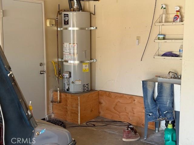 15163 Tournament Dr, Helendale, CA 92342 - utility room featuring strapped water heater