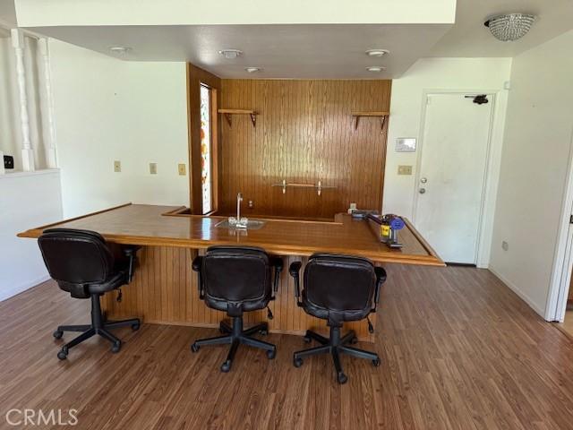 15163 Tournament Dr, Helendale, CA 92342 - office area featuring wood finished floors and bar with sink
