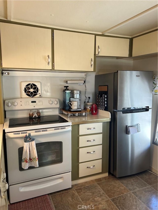38150 Sumac Ln, Squaw Valley, CA 93675 - kitchen with electric range, freestanding refrigerator, light countertops, and dark stone finish flooring
