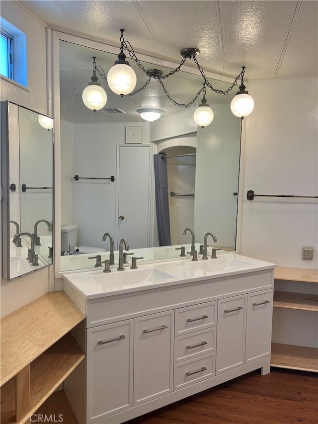 38150 Sumac Ln, Squaw Valley, CA 93675 - full bathroom with double vanity, wood finished floors, and a textured ceiling