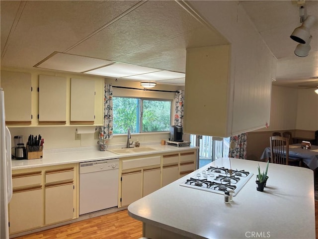 38150 Sumac Ln, Squaw Valley, CA 93675 - kitchen with white appliances, light wood finished floors, light countertops, and cream cabinets