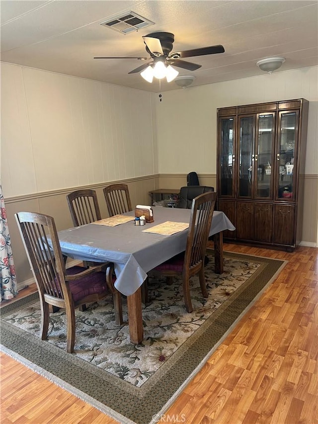 38150 Sumac Ln, Squaw Valley, CA 93675 - dining area with light wood-style floors, a ceiling fan, and a decorative wall