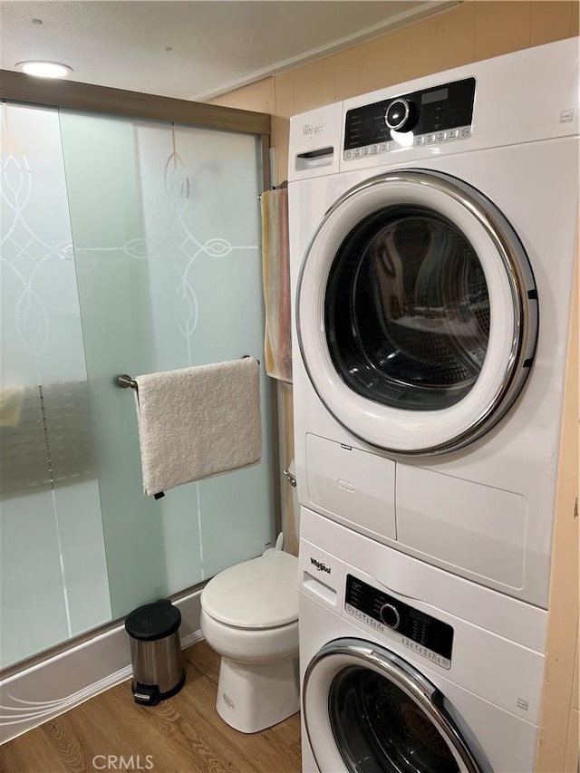 38150 Sumac Ln, Squaw Valley, CA 93675 - laundry area featuring stacked washer / dryer and wood finished floors